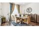Elegant dining room with glass table, upholstered chairs, and stylish decor at 9503 Richfield St, Commerce City, CO 80022