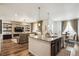 Open concept kitchen featuring an island with seating, granite countertops, and wood floors at 9503 Richfield St, Commerce City, CO 80022