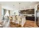 Modern kitchen with a large island, dark cabinets, and stainless steel appliances at 9503 Richfield St, Commerce City, CO 80022