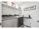 Well-organized laundry room with modern Samsung washer and dryer and ample shelving at 9503 Richfield St, Commerce City, CO 80022