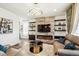 Comfortable living room with a stone fireplace, floating shelves, and modern decor at 9503 Richfield St, Commerce City, CO 80022
