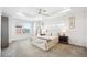 Spacious main bedroom featuring a tray ceiling, ceiling fan, and ample natural light at 9503 Richfield St, Commerce City, CO 80022