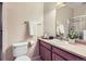 Functional bathroom featuring a single sink, wood cabinets, a toilet, and a shower with glass doors at 8915 Federal Blvd # 203, Denver, CO 80260