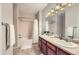 Functional bathroom featuring double sinks, a bath/shower combo with a white curtain, and neutral finishes at 8915 Federal Blvd # 203, Denver, CO 80260