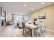 Open-concept living space with dining area flowing into a cozy living room at 8915 Federal Blvd # 203, Denver, CO 80260