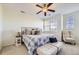 Serene primary bedroom with natural light, a ceiling fan, and a cozy sitting area at 8915 Federal Blvd # 203, Denver, CO 80260