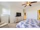 Bright main bedroom featuring a ceiling fan, white dresser, and comfortable bed with a blue patterned comforter at 8915 Federal Blvd # 203, Denver, CO 80260