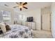 Spacious bedroom with a ceiling fan, soft carpet, and ample natural light at 8915 Federal Blvd # 203, Denver, CO 80260