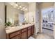 Bathroom with double sinks, vanity, and view into the bedroom at 8915 Federal Blvd # 203, Westminster, CO 80260