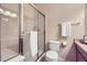 Clean bathroom showcasing a shower stall with glass doors, a toilet, and tiled flooring at 8915 Federal Blvd # 203, Westminster, CO 80260