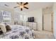 Bright bedroom featuring a ceiling fan, multiple windows, and stylish furniture at 8915 Federal Blvd # 203, Westminster, CO 80260