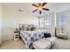 Serene bedroom with a ceiling fan, natural light, and stylish furniture at 8915 Federal Blvd # 203, Westminster, CO 80260
