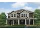 Beautiful townhome featuring black siding, gray accents, and a well-maintained lawn at 1372 S Boston Ct # A, Denver, CO 80247