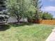 Well-maintained backyard featuring lush green grass, mature trees, and a privacy fence at 5695 W 109Th Cir, Westminster, CO 80020