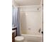 Bathroom with a white tiled shower over a bathtub and toilet at 5695 W 109Th Cir, Westminster, CO 80020