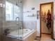 Relaxing bathroom with a soaking tub, glass shower, and tile surround at 5695 W 109Th Cir, Westminster, CO 80020