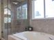 Bathroom showcasing a walk-in shower with beautiful tile and window at 5695 W 109Th Cir, Westminster, CO 80020