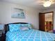 Well-lit bedroom with a patterned comforter and an open doorway at 5695 W 109Th Cir, Westminster, CO 80020