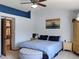 Spacious bedroom featuring a queen-sized bed, blue accent wall, and natural light at 5695 W 109Th Cir, Westminster, CO 80020