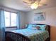 Comfortable bedroom featuring a ceiling fan, a window with curtains, and a cozy bed with patterned bedding at 5695 W 109Th Cir, Westminster, CO 80020