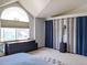Bright bedroom with a large window, dresser, and textured ceiling at 5695 W 109Th Cir, Westminster, CO 80020