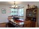 Cozy dining room featuring a chandelier, large table, and a window with natural light and a decorative shelf at 5695 W 109Th Cir, Westminster, CO 80020