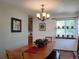 Cozy dining area featuring a chandelier, large table, and window with natural light and wall art at 5695 W 109Th Cir, Westminster, CO 80020
