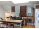 Kitchen featuring dining area, brick fireplace, and dark countertops at 5695 W 109Th Cir, Westminster, CO 80020