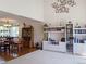 Cozy living room featuring hardwood floors, shelving units, and a dining area with natural light at 5695 W 109Th Cir, Westminster, CO 80020