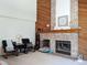 Cozy living room with brick fireplace, wood accents, and comfortable seating arrangement at 5695 W 109Th Cir, Westminster, CO 80020