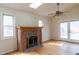 Bright living room with a skylight, brick fireplace, and natural light through the glass patio doors at 2735 S Humboldt St, Denver, CO 80210