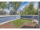 Well-kept backyard features artificial turf and wood chip sections, enhanced by a blue fence at 5016 S Nelson St # C, Littleton, CO 80127