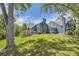 Expansive backyard showcases a well-maintained lawn, mature trees, and the blue home exterior at 5016 S Nelson St # C, Littleton, CO 80127