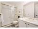Bathroom featuring a shower with glass door, vanity, and gold fixtures, creating a luxurious and functional space at 5016 S Nelson St # C, Littleton, CO 80127