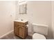 Traditional bathroom features a wood vanity, decorative mirror, and standard toilet at 5016 S Nelson St # C, Littleton, CO 80127