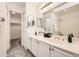 Bright bathroom with double vanity, neutral walls, large mirror, and walk-in closet at 5016 S Nelson St # C, Littleton, CO 80127