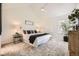 Bright bedroom with vaulted ceiling, ceiling fan, neutral walls and carpet with bedside tables, lamps and decorative plants at 5016 S Nelson St # C, Littleton, CO 80127