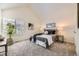 Bright bedroom with vaulted ceiling, neutral walls and carpet with bedside tables, lamps and decorative plants at 5016 S Nelson St # C, Littleton, CO 80127