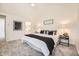 Bright bedroom with vaulted ceiling, neutral walls and carpet, white bed linens, bedside tables and decor at 5016 S Nelson St # C, Littleton, CO 80127