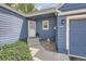 Inviting entrance showcasing blue siding, a well-manicured yard, and a charming walkway leading to the front door at 5016 S Nelson St # C, Littleton, CO 80127