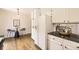Efficient kitchen featuring white cabinets, black countertops, and a breakfast nook for casual dining at 5016 S Nelson St # C, Littleton, CO 80127