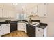 Functional kitchen with white cabinets, black appliances, and laminate countertops, perfect for meal preparation at 5016 S Nelson St # C, Littleton, CO 80127