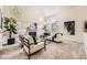 Bright living room features high ceilings, large windows, a cozy fireplace, and modern decor at 5016 S Nelson St # C, Littleton, CO 80127