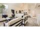 Open-concept living room with contemporary furnishings, a soaring ceiling, and seamless flow to the dining area at 5016 S Nelson St # C, Littleton, CO 80127