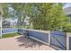 Private patio with a blue fence, a wooden deck, a chair, and lush landscaping at 5016 S Nelson St # C, Littleton, CO 80127