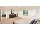 Bright bedroom with large window, dresser, and comfortable seating area at 22313 E 38Th Pl, Aurora, CO 80019
