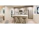 Modern kitchen with white cabinets, island, and stainless steel appliances at 22313 E 38Th Pl, Aurora, CO 80019