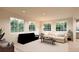 Bright living room featuring large windows and a comfortable layout at 22313 E 38Th Pl, Aurora, CO 80019