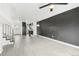 Bright living room with modern light fixture, staircase, and open to kitchen and entry at 5711 W 92Nd Ave # 25, Westminster, CO 80031