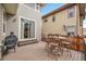 Cozy back deck with a grill, dining furniture, and sliding glass doors to home interior at 10452 Rutledge St, Parker, CO 80134